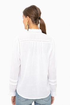 Embrace casual bohemian vibes in this peasant style blouse. Featuring romantic blouson sleeves and delicate embroidery along on the neckline and chest, this relaxed and graceful top exudes laid back femininity.

Ladder Trim
Picot Ruffle Sleeves & Neck
Clip Dot Cuffs
Pearl Buttons
100% Cotton
Care: Machine wash cold, lay flat to dry Peasant Top With Blouson Lantern Sleeves And Relaxed Fit, Casual Peasant Top With Blouson Sleeves For Brunch, Casual White Blouse With Boho Collar, Spring Peasant Top With Blouson Sleeves And Relaxed Fit, White Casual Peasant Top With Blouson Sleeves, Flowy Long Sleeve Tops With A Free-spirited Style, White Tops With Smocked Cuffs And Relaxed Fit, White Casual Peasant Top With Lantern Sleeves, Spring Long Sleeve Blouse With A Free-spirited Style