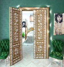 an open door in a room with green chairs and pictures on the wall behind it