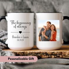 two personalized coffee mugs sitting on top of a wooden table next to a blanket