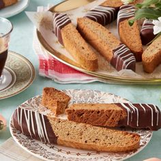 slices of cake sitting on plates next to cups and saucers