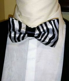 "Stunning and classic bow tie has been design in exotic, bright satin prints. The Unisex bow ties are an excellent evening addition to any wardrobe. You will look unique at any special occasion. Our bow ties are made in fine satin with interfacing to give it, stability and shape. Approximate Measurements: Bow: 5\" x 2.5\" Adjustable Strap: 14\" x 19\" Bow Tie care recommended Dry Clean only. All items are sent Via USPS First Class Mail within the U.S. shipping times take an average of 5-7 Busine Wedding Satin Ties With Satin Finish, Elegant Bow Tie With Inside Ties For Party, Fitted Satin Tie For Black Tie Occasions, Fitted Satin Tie For Wedding, Tuxedo Style Bow Tie Back Ties For Wedding, Fitted Satin Ties For Black-tie Events, Silver Party Tie, Classic Satin Finish Tie For Party, Wedding Ties With Satin Finish