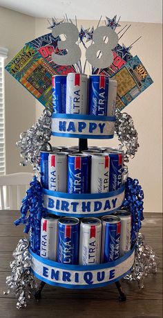 a birthday cake made out of cans and tinsels