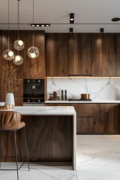 a modern kitchen with marble counter tops and wooden cabinets, along with pendant lights hanging from the ceiling