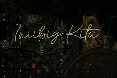 the word nilbig kita is lit up in front of a dark background