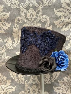 Hat  Steampunk Gothic Top Hat grey/ black vintage  print  Top Hat fully lined size 61cm . It has lots of detail including blue embroidery trim and roses please refer to photos The Hat is brand new and unworn.high quality by Raven SDL . Any traces of glue is not a defect but characteristics of a hand made hat  Thank you for looking Steampunk Top, Steampunk Festival, Steampunk Top Hat, Gothic Tops, Des Roses, Top Hats, Gothic Steampunk, Steampunk Design, Fancy Hats