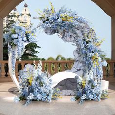 an arch decorated with blue and yellow flowers