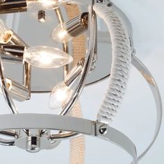 a close up of a light fixture with ropes and lights attached to the bulb cover