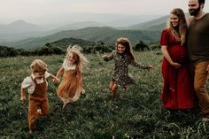 a group of people that are standing in the grass