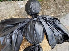 a black plastic bag sitting on top of a sidewalk