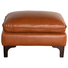 a brown leather ottoman with wooden legs