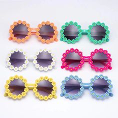 Adorable Daisy Flower Sunglasses for Your Little Sunshine Brighten up your child's day with our Kids Round Daisy Flower Sunglasses! Designed for outdoor sun protection, these charming and whimsical shades add a dash of retro flair to any outfit. The round frames, decorated with cute daisy petals, come in six cheerful colors, perfect for any little girl's sunny adventures. Whether it's a family outing, beach day, or festival party, these sunglasses will help your child step out in style while keeping their delicate eyes safe from harmful UV rays. Outstanding Features of Kids Daisy Sunglasses Retro Fashion: Cute round daisy flower frames capture the playful spirit of the past while adding a modern, fun twist. Six Vibrant Colors: Choose from a range of colorful frames to match your child's pe Fun Multicolor Sunglasses For Spring, Adjustable Round Frame Sunglasses For Beach, Playful Multicolor Sunglasses For Spring, Fun Multicolor Spring Sunglasses, Whimsical Sunglasses With Uv Protection For Beach, Playful Polarized Sunglasses For Spring, Whimsical Beach Sunglasses With Uv Protection, Cute Flower Shaped Sunglasses With Uv Protection, Cute Adjustable Sunglasses For Spring