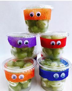 four plastic containers filled with pickles and eyes