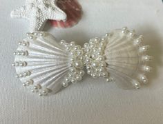 Barrette Silver Tone Shells hand painted pearl white Pearls different sizes added Looks like a bow. Handmade in Florida May be slightly different than pictures due to using different shells shells ate not smooth and may have tiny imperfections. They are found on the beach. Last pictures  Barrette is 3" Across with shells approx 3.5" Perfect gift for her Special party or event Free shipping within the USA Custom orders welcomed, if you are looking for particular colors or shells. Shell Hair Accessories, Shell Hair Clips, White Beach Wedding, Sea Hair, Beach Wedding Party, Beach Wedding White, Wedding Party Bridesmaid, Wedding Barrettes, Pearl Paint