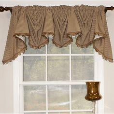 a window with a brown and white checkered valance