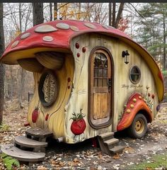 a small house made out of wood with a red roof and mushroom like design on the side