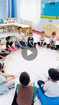 a group of children sitting in a circle on the floor