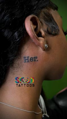 a woman with tattoos on her neck and behind the ear that reads, hero tattoo