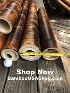 bamboo tubes are stacked on top of each other with a measuring tape next to them