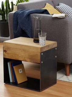 a living room with a couch, coffee table and bookshelf