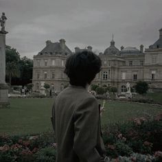 a woman standing in front of a large building