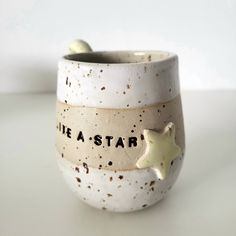 there is a ceramic cup with stars on it