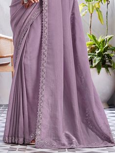 Introducing a mesmerizing light purple chiffon saree embellished with exquisite sequin and embroidered work, designed to elevate your ethnic wardrobe for upcoming parties, events, and special occasions. This ethereal saree exudes elegance and grace, combining the delicate sheen of chiffon with intricate detailing that catches the light beautifully. The soft hue of light purple complements a variety of skin tones, ensuring a flattering and sophisticated look for every wearer.
Accompanying the sar Purple Georgette Pre-draped Saree For Eid, Embroidered Purple Georgette Pre-draped Saree, Purple Embellished Pre-draped Saree, Embellished Purple Pre-draped Saree, Purple Embellished Georgette Pre-draped Saree, Elegant Lavender Dupatta With Intricate Embroidery, Elegant Lavender Embroidered Dupatta, Purple Embroidered Georgette Pre-draped Saree, Purple Pre-draped Saree With Mirror Work For Eid