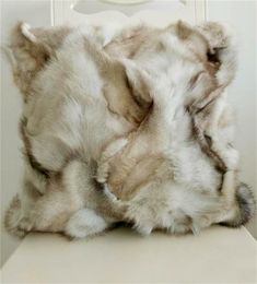 an animal fur pillow sitting on top of a white table