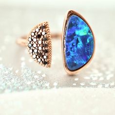 two rings that have been set on top of each other, one is blue and the other has black diamonds