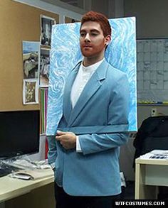 a man in a blue suit is holding a painting