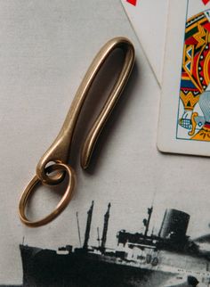 a pair of scissors sitting on top of a piece of paper next to a playing card