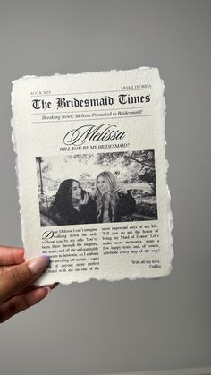 a person holding up a newspaper with an image of two women on it and the words, the bridesmaid times