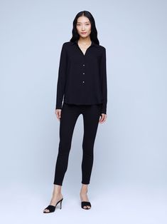 A modern classic. The Nina blouse is structured in all the right places with a relaxed, flattering fit. Refined button-down construction with a chic open collar and draped long sleeve in black silk. Chic Business Casual Blouse With Lapel Collar, Timeless Office Blouse With Lapel Collar, Modern Blouse With Lapel Collar For Office, Tailored Button-up Blouse For Business Casual, Viscose Button-up Work Shirt, Versatile Black Blouse For Business Casual, Viscose Button-up Shirt For Work, Sleek Spread Collar Blouse For Work, Sleek Blouse With Spread Collar For Work