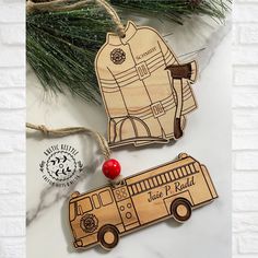 two wooden ornament shaped like fire trucks