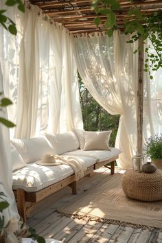 a white couch sitting on top of a wooden floor next to a covered patio area