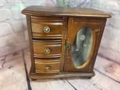 a small wooden cabinet with a mirror on it