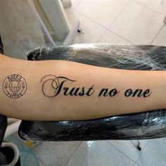 a tattoo that says trust no one on it