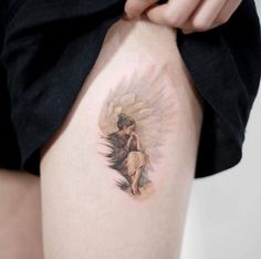 a woman with a tattoo on her thigh