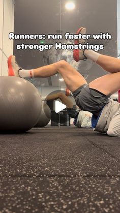 a man laying on top of an exercise ball with his legs spread out in front of him