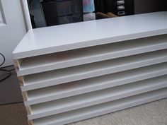 several stacks of white plywood boards stacked on top of each other