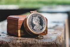 an old coin sitting on top of a wooden box