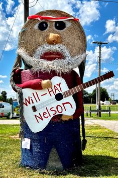 a statue of a man with a guitar in his hand and the words will - hay nelson written on it