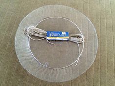 a round glass table with a string on it and a package of hemp cord in the middle