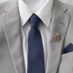 a man wearing a suit and tie with a lapel pin on his lapel