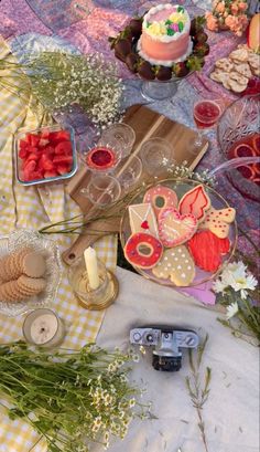 a table topped with lots of food and desserts