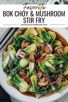 a white bowl filled with stir fry vegetables and broccoli on top of a table