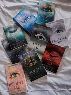 six books laying on top of a bed next to each other in front of an eye