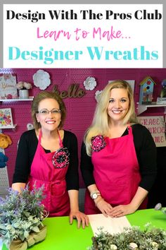 two women in pink aprons standing behind a green table with flowers on it and the words design with the pros club learn to make designer wreaths