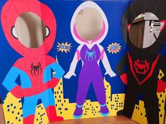 two cardboard cut outs of superheros and spider - man