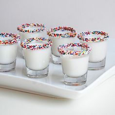 small glasses filled with sprinkles on a tray