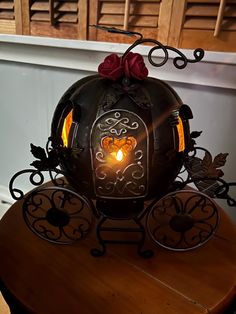 a pumpkin shaped lantern sitting on top of a wooden table